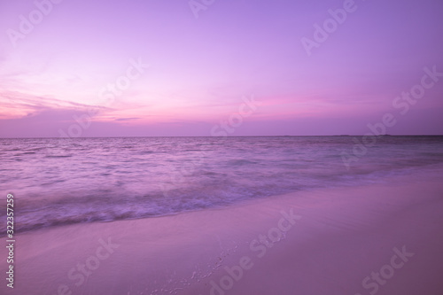 Fototapeta Naklejka Na Ścianę i Meble -  Sea sand sky concept, sunset colors clouds, horizon, horizontal background banner. Inspirational nature landscape, beautiful colors, wonderful scenery of tropical beach. Beach sunset, summer vacation