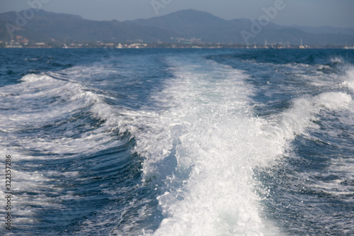 Sea wave ripple behind speed boat while sailing in the ocean