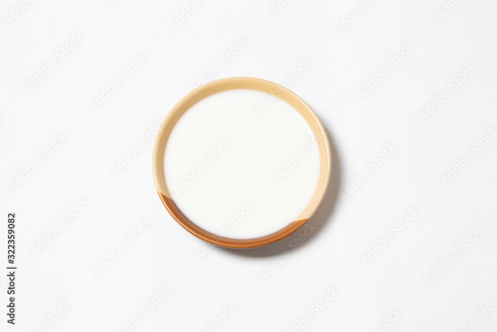 Plate with milk on white background Plate with milk on white background