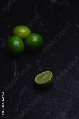 Lime cut in half on a dark distressed background © Stely