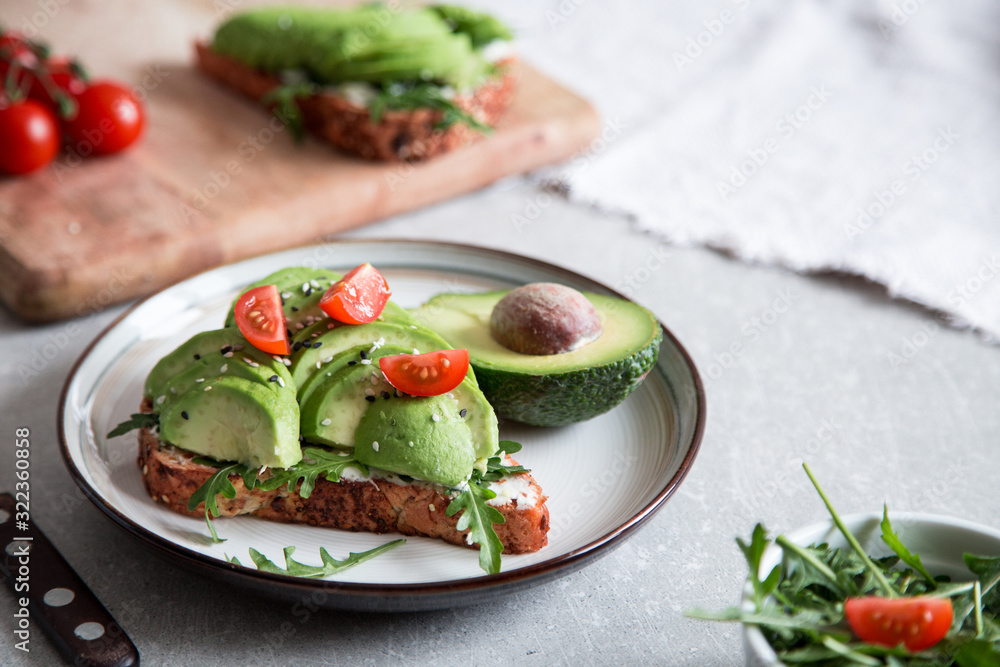healthy breakfast with avocado and Delicious wholewheat toast. sliced avocado on toast bread with spices. Mexican cuisine healthy breakfast with avocado and Delicious wholewheat toast. sliced avocado on toast bread with spices. Mexican cuisine