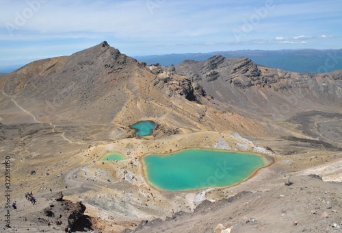 Awesome view of the vulcanic green lakes on the alpine mountain in the Tongariro National Park, hikers Walking down the track 