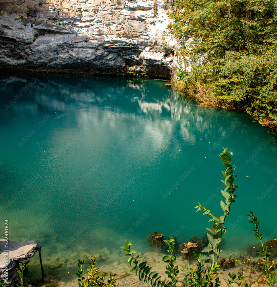 Blue lake located in the gorge of the Caucasus mountains with a depth of more than 100 meters