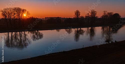 Beautiful sunset with reflections at the river danube near Winzer, Bavaria, Germany © Martin Erdniss