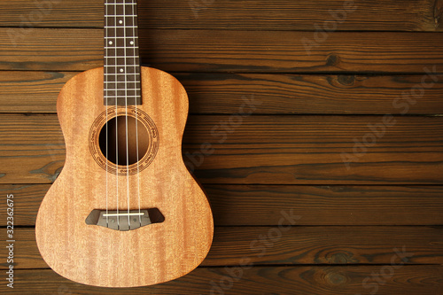 Ukulele on wooden background