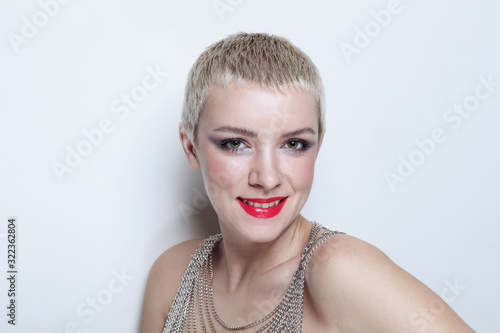 Photos Vintage style portrait of young smiling woman with short blonde hair and fancy m