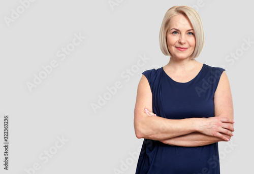 Friendly smiling middle-aged business woman isolated on white ba