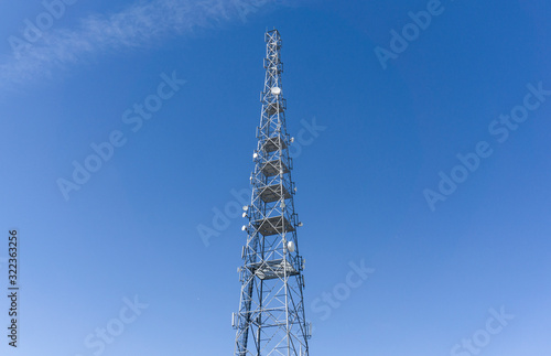 tower with mobile operator antennas on the background sky