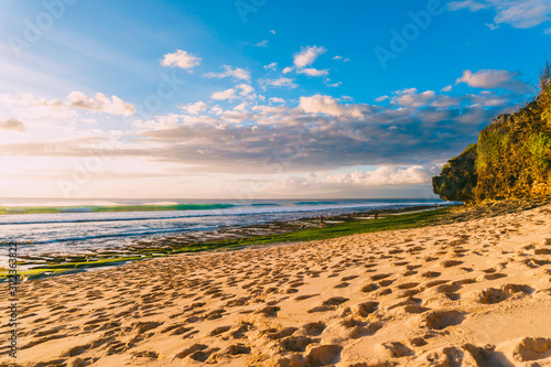 Beach and ocean with waves in tropical island with sunset light