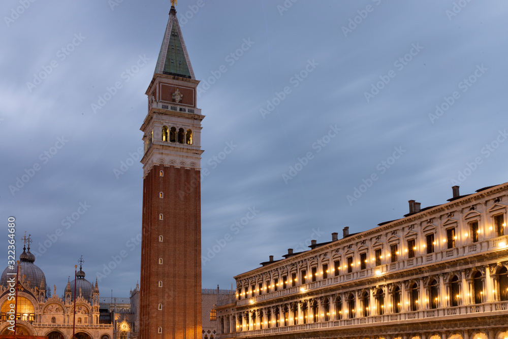 Night view of Piazza San Marco with a view of the basilica, the bell tower and the new Procuratie Venice, Italy. Suggestive lights at dayfall.