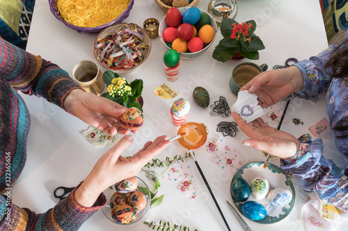 Принти на полотні White table with colored Easter eggs in baskets and bowls on it, along with a lot of arts and crafts tools