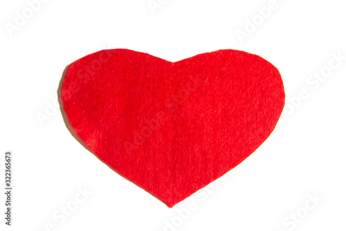 Heart made of felt on a white background. A red heart cutted from felt
