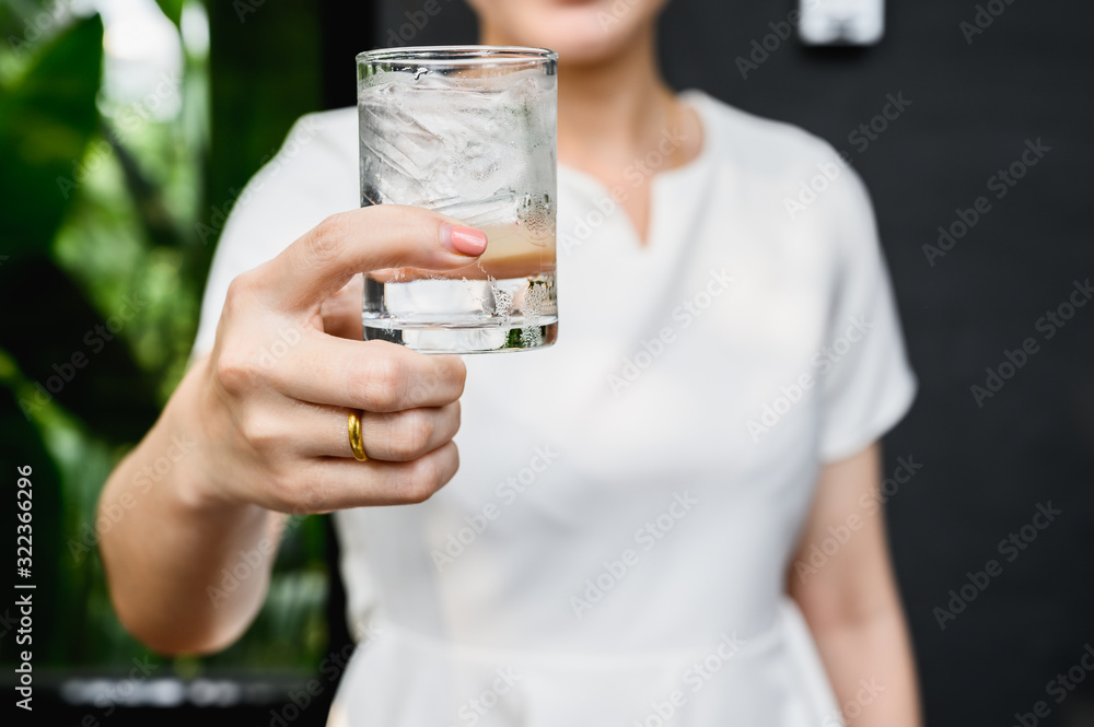 healthy beautiful young woman holding glass of water