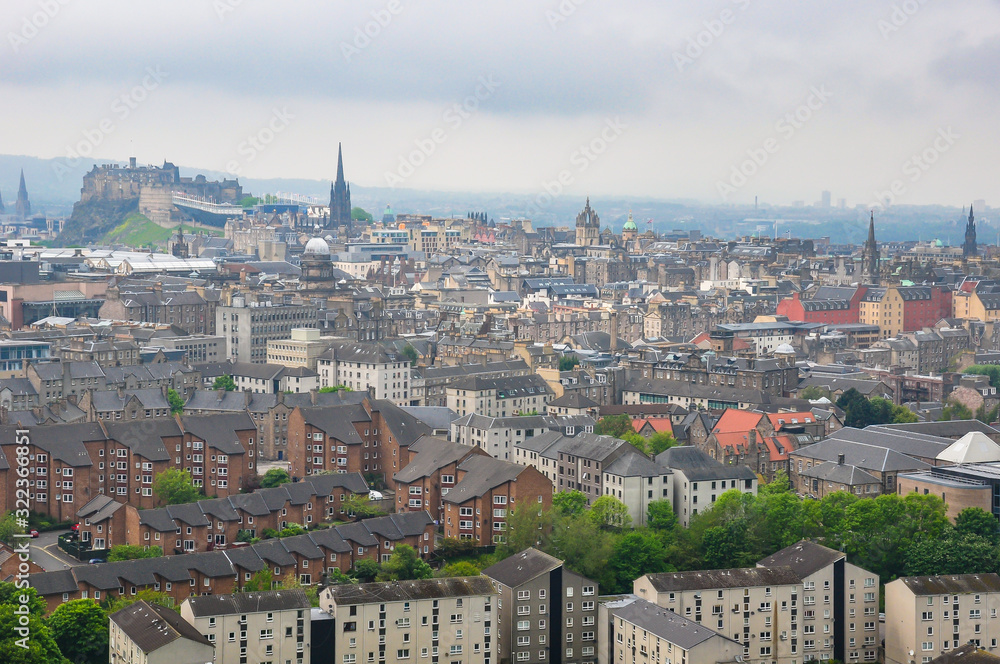 Cityscape of the City of Edinburgh and its famous Castle on a typical foggy summer afternoon
