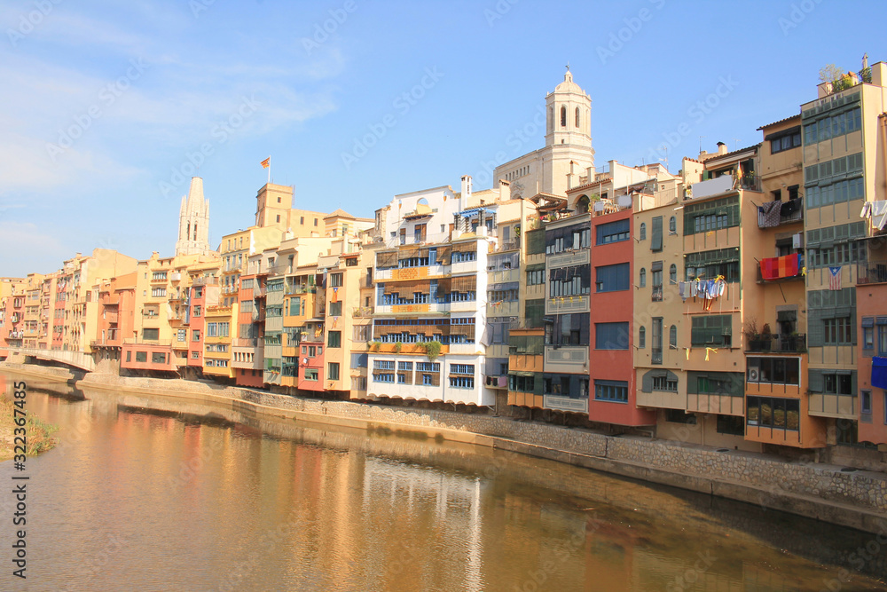 The amazing colorful houses along the river Onyar and the Cathedral of Saint Mary in the gorgeous city of Girona, Catalonia, Spain. The amazing colorful houses along the river Onyar and the Cathedral of Saint Mary in the gorgeous city of Girona, Catalonia, Spain.