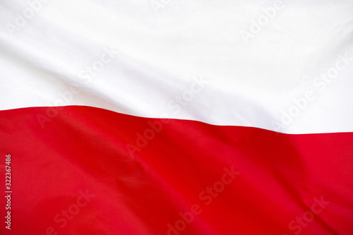 Fabric texture flag of Poland. Flag of Poland waving in the wind. Poland flag is depicted on a sports cloth fabric with many folds. Sport team banner.