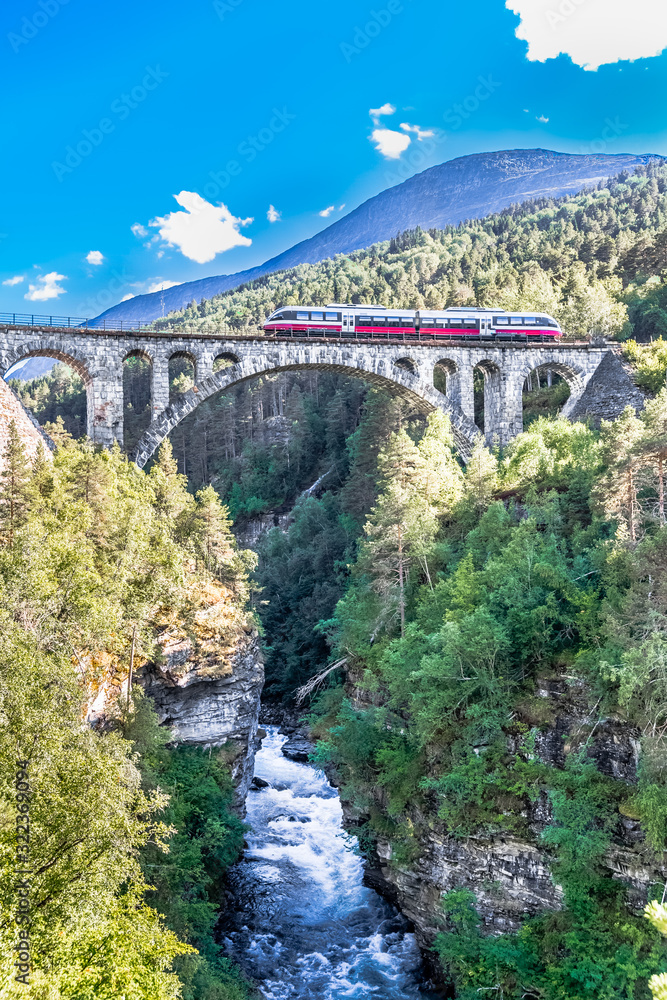 VERMA, NORWAY - 2018 AUGUST 01. Kylling bridge with the river below and train on the top.