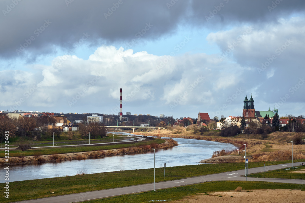Fototapeta premium Urban landscape with river Warta and the cathedral towers in Poznan.