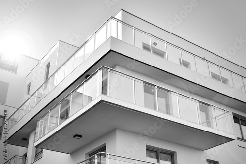 Detail of modern residential flat apartment building exterior. Fragment of new luxury house and home complex. Black and white. © Grand Warszawski