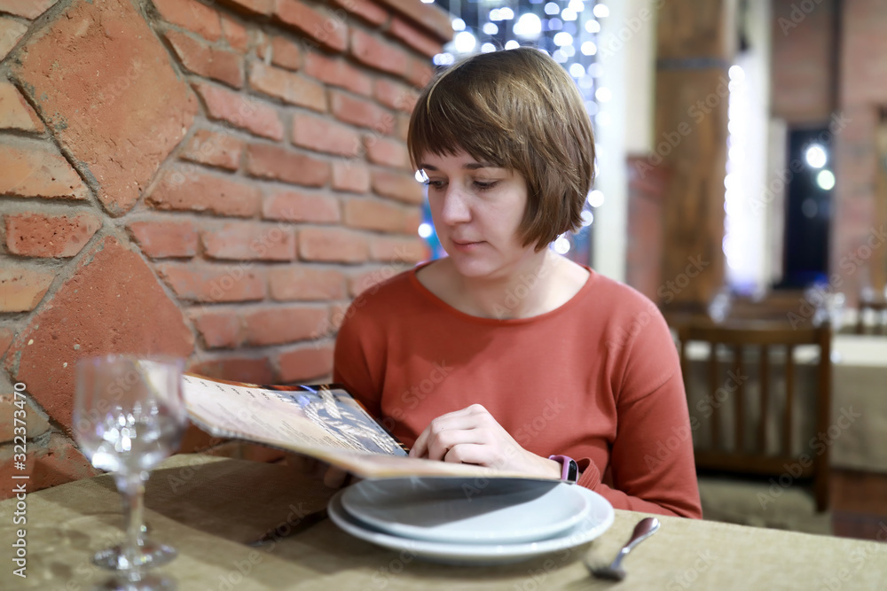 Woman looking at menu book Woman looking at menu book