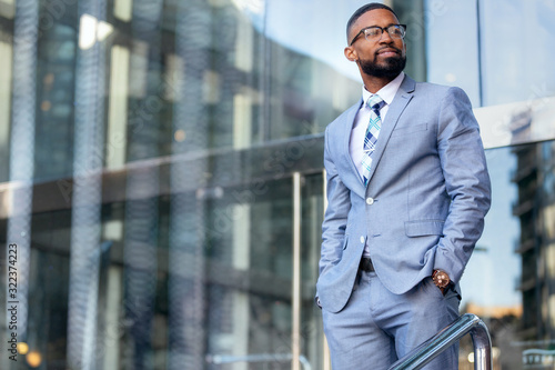 Obraz na plátně Handsome male african american business man CEO in a stylish chic suit at the wo
