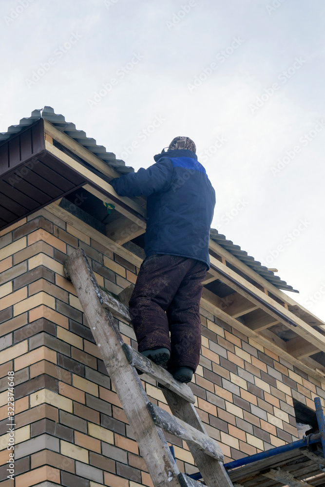 man stands on the stairs at a construction site