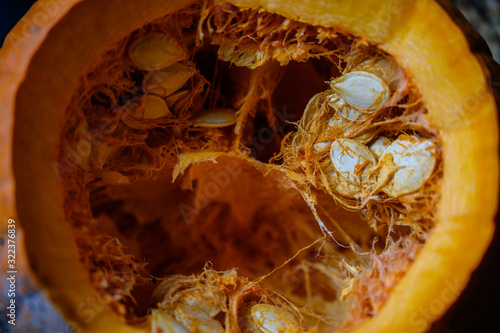 Top view looking into an open pumpkin with seeds