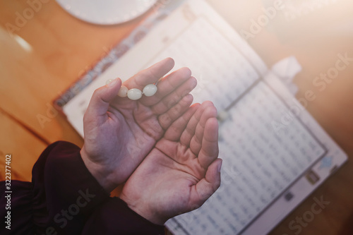Wallpaper Mural Praying young muslim woman. Middle eastern girl praying and reading the holy Quran. Muslim woman studying The Quran Torontodigital.ca