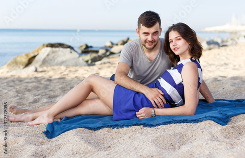 Positive loving couple resting and hugging