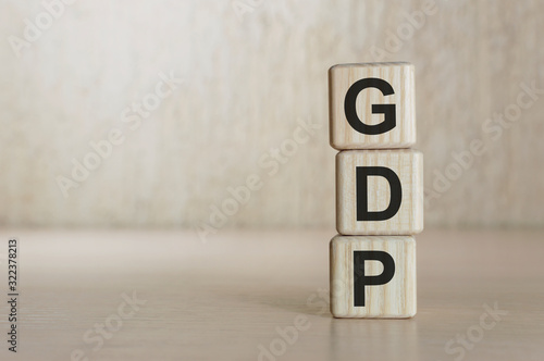 GDP word written on wood block. GDP text on wooden table for your desing, concept.