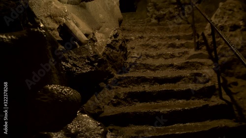 Old weathered stairs in a dark cave. photo