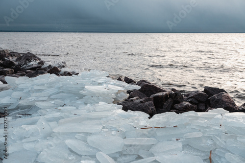 Natural background of ice. Large chunks of ice underfoot. Ice on the Bay.