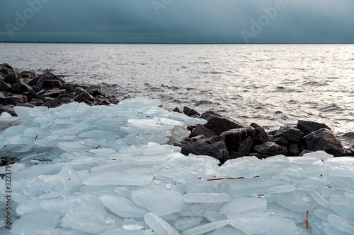 Piece of ice. Broken ice on the shore of the Gulf of Finland. Transparent ice.