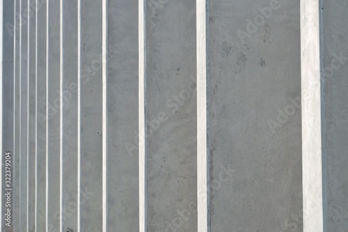 Blurred a row of grey cement poles pattern with day light for background texture,architecture backdrop