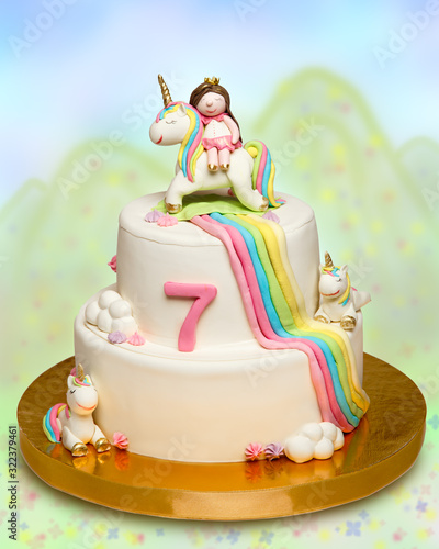 Cake for children on birthday celebration with homemade little princess and unicorn fondant figures