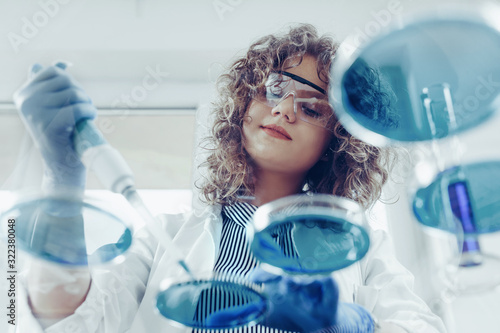 Young scientist working at the lab. Young female scientist doing some research. photo