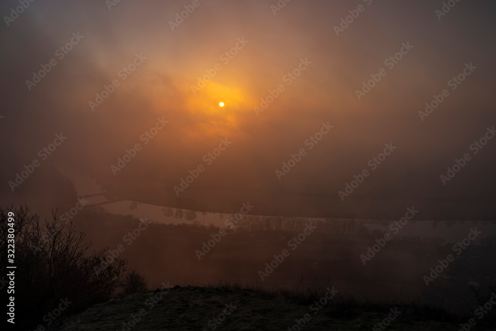 Sunrise time on Radobyl hill over valley of river Labe and Litomerice town