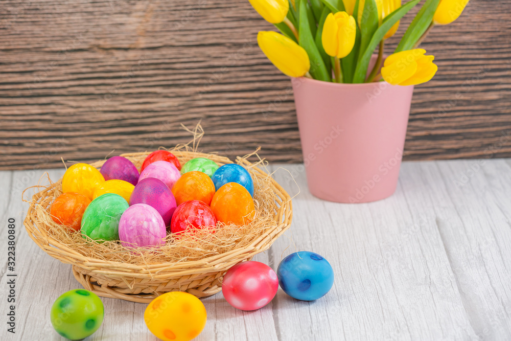 Beautiful group Easter eggs in the spring of easter day, red eggs, blue, purple and yellow in Wooden basket on the table background wood. Beautiful group Easter eggs in the spring of easter day, red eggs, blue, purple and yellow in Wooden basket on the table background wood.