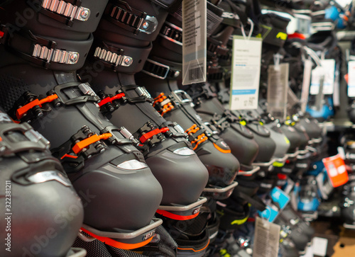row of ski boots in the sports store, original sports equipment