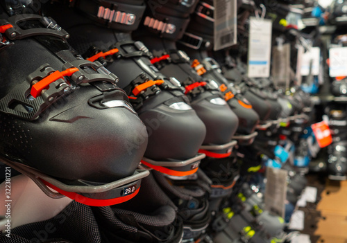 row of ski boots in the sports store, original sports equipment