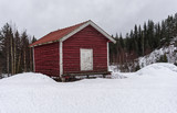 Old traditional Norwegian building surrounded by winter landscape 