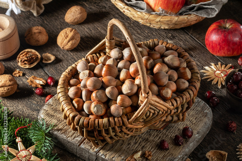 Hazelnuts in a basket, with Christmas decoration on a table