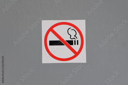 No smoking sign on gray wall, concept of health care, smoking cessation.
