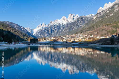 The view of Auronzo and the frozen lake Santa Katerina, Dolomites, Italy