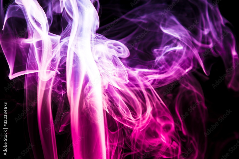 Naklejka premium Colored smoke on black background