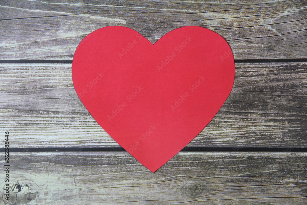 Red heart made of paper symbol of love on a background of wooden boards Red heart made of paper symbol of love on a background of wooden boards