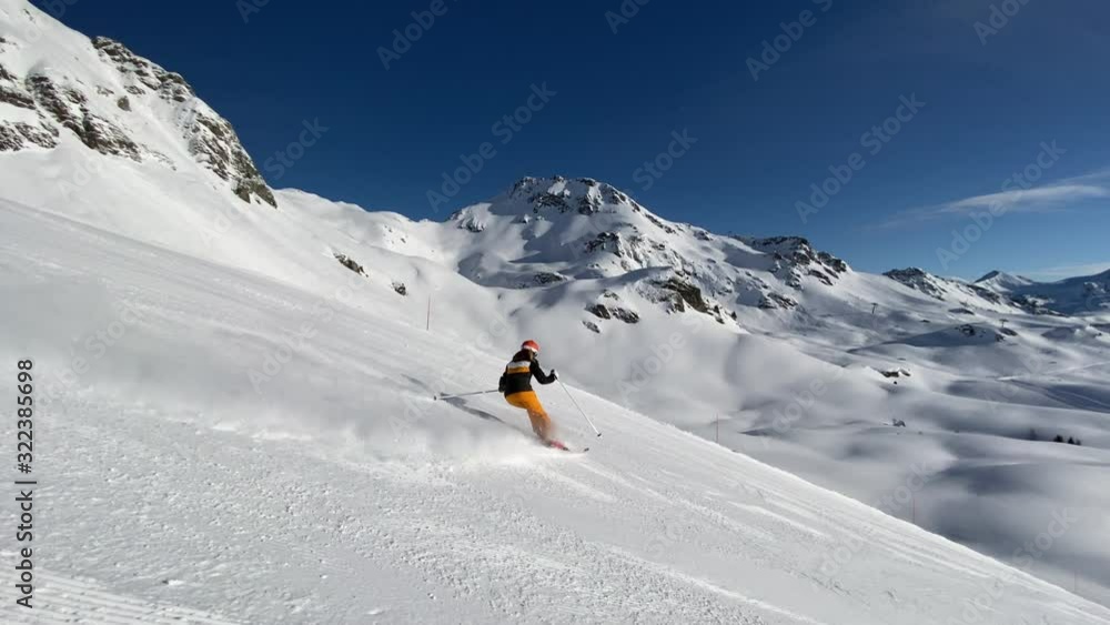 4K slow motion video woman skiing on ski slope on sunny winter day in beautiful alpine mountains 4K slow motion video woman skiing on ski slope on sunny winter day in beautiful alpine mountains