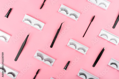 Valokuva Various tools for eye lash extensions on a trendy pastel pink background