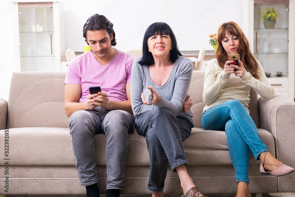Young family and mother-in-law in family issues concept Young family and mother-in-law in family issues concept