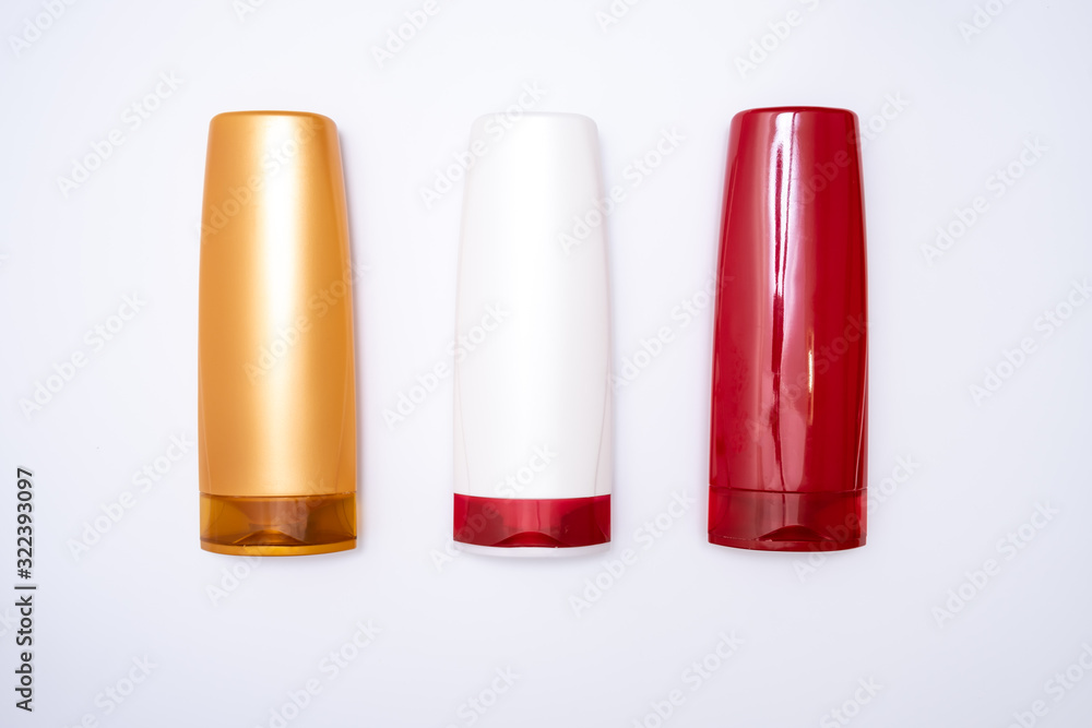 Colorful plastic shampoo and hair conditioner bottles on white background, haircare concept Colorful plastic shampoo and hair conditioner bottles on white background, haircare concept